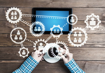 Concept of teamworking and connection with gears mechanism and tablet pc
