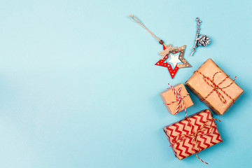 Blue Christmas background with gift boxes, baubles and copy space.