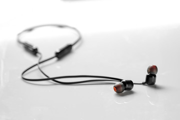 stylish black wireless in-ear headphones on white background