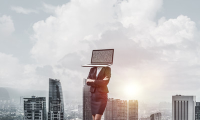Business woman with laptop instead of head.