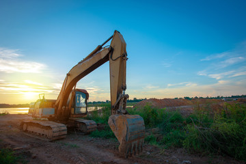 Fototapeta na wymiar backhoe to excavate the soil on the ground. wheel loader,dig the ground.
