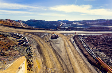 Obraz premium Aerial view of opencast mining quarry with the blue sky and clouds