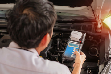 technician are conducting car check for car repair. with sun light