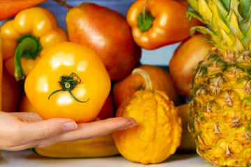 Summer yellow healthy organic antioxidant tomato, veggies vegetables and fruits: pepper, pumpkin, pear orange as symbol of healthy eating, diet and lifestyle. Fridge, vegan. vegetarian and raw concept