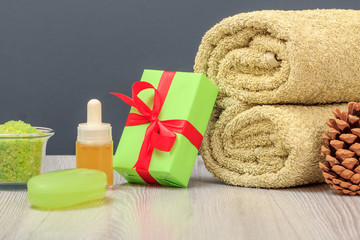Obraz na płótnie Canvas Spa composition with towel, gift box, oil, sea salt and soap.