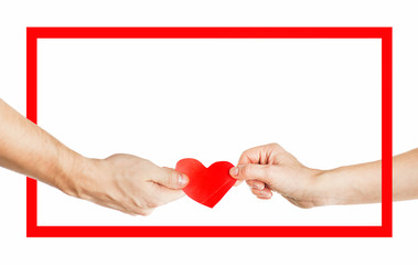The hands of people hold a red heart in a red frame. Valentines day relationship concept. On isolated background