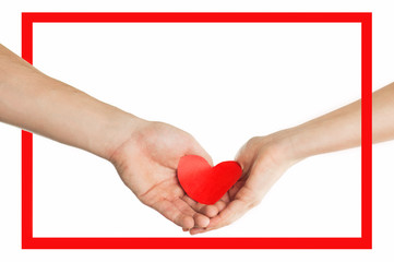 The hands of people hold a red heart in a red frame. Valentines day relationship concept. On isolated background