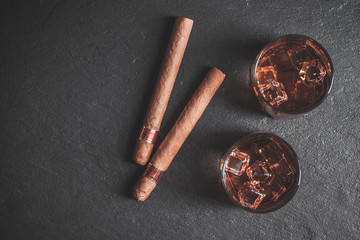 Whiskey with ice and cigar. Top view. Copy space. 