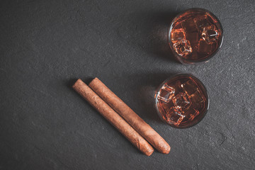 Whiskey with ice and cigar. Top view. Copy space. 