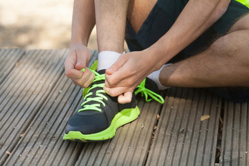 Runner trying running shoes getting ready for run.