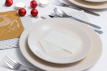 Place setting with Christmas wafer on empty plate