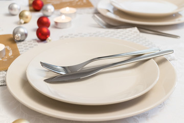 Cutlery on empty place setting on white table on holiday