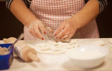 Obraz na płótnie Canvas Woman kneading dough on table, closeup