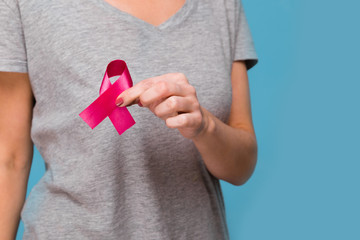 Elderly woman holding purple ribbon awareness w copy space. Symbol is used to raise awareness for...