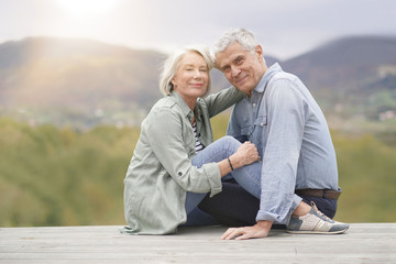 Loving full length portrait of modern senior couple outdoors