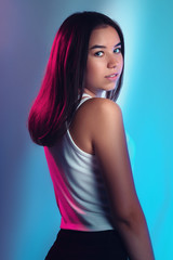 Fototapeta premium Portrait of beautiful girl in studio with color filters