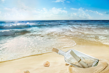 Fototapeta na wymiar Sandy beach. Bottle with the message on the seashore.