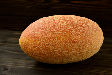 Fresh melons on old black wooden table