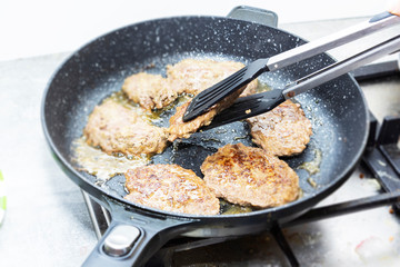 big and juicy cutlet on a metal stand. Home kitchen
