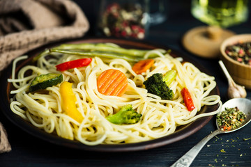 pasta with fried vegetables and spices and seasoning on a plate