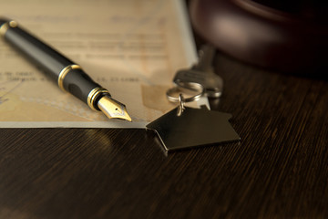 rental contract. A rental agreement / lease document with keys and pen.Keys on the signed contract...