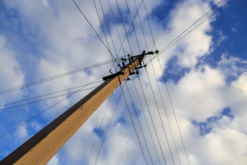 Electric pole with wires against the sky