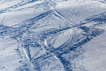 Traces of skiers on white snow in the mountains