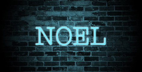 Fototapeta premium first name Noel in blue neon on brick wall