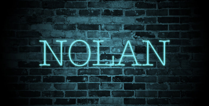 first name Nolan in blue neon on brick wall