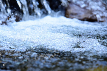 Water surface with ripples and sunrays reflections