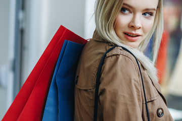 Close up of a happy woman. Time for shopping with cool handbags. Consumerism, shopping, lifestyle concept