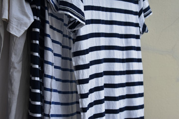 Striped T-Shirt hanging from rail, Drying clothes concept.