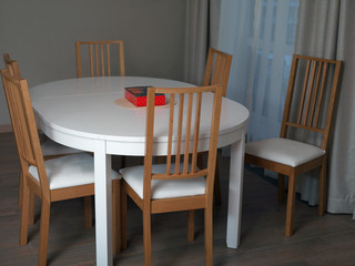 Fototapeta na wymiar Dinner table and chairs