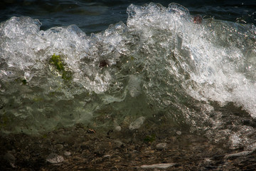 Background blue waves of the sea with foam