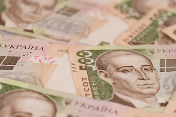A close-up of a pattern of many Ukrainian currency banknotes with a par value of 500 hryvnia. Background image on business in Ukraine.