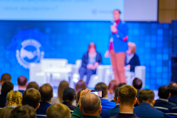 People attend business conference in the congress hall