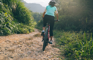Fototapeta na wymiar Woman cyclist riding a bike on a nature trail in the mountains.people living a healthy lifestyle