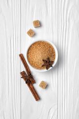 Top view of brown cinnamon granulated and cane cubes sugar with spices for confectionery