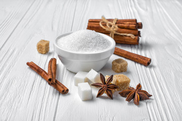 White granulated and cane cubes sugar with different spices for confectionery