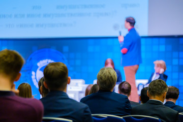 People attend business conference in the congress hall