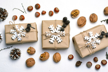 Christmas Gifts, Nuts, Pine Cones on White Background, Nacural Decor Materials, Winter Holidays Concept