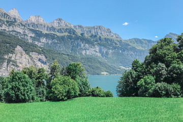 Lake Walensee on the background of the mountains, the view from the shore, Switzerland