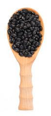 black beans in wood ladle isolated on white background © cloud7days