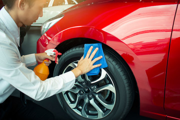 Man asian inspection and cleaning Equipment car wash With red car For cleaning to quality to customer on car showroom of service transport automobile transportation automotive image.