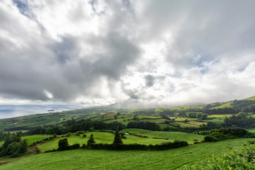 Pastures with beautiful clouds in the summertime near Vila Franca do Campo in the Azores, Portugal.