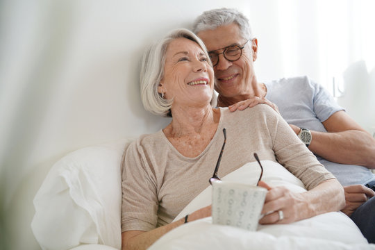 Portrait of senior couple relaxing in bed