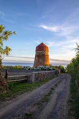 An old windmill next to a gravel road in the Feteiras on Sao Miguel.