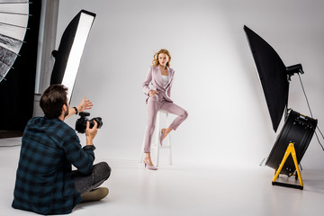 young photographer shooting beautiful stylish young woman in photo studio © LIGHTFIELD STUDIOS