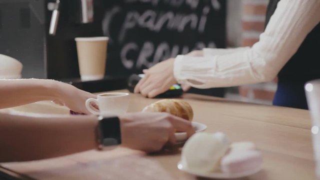 Purchase of croissant and coffee at the bar in caffe