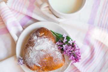 Delicious bakery cakes, buns with jam and violet flowers. Food and spring concept